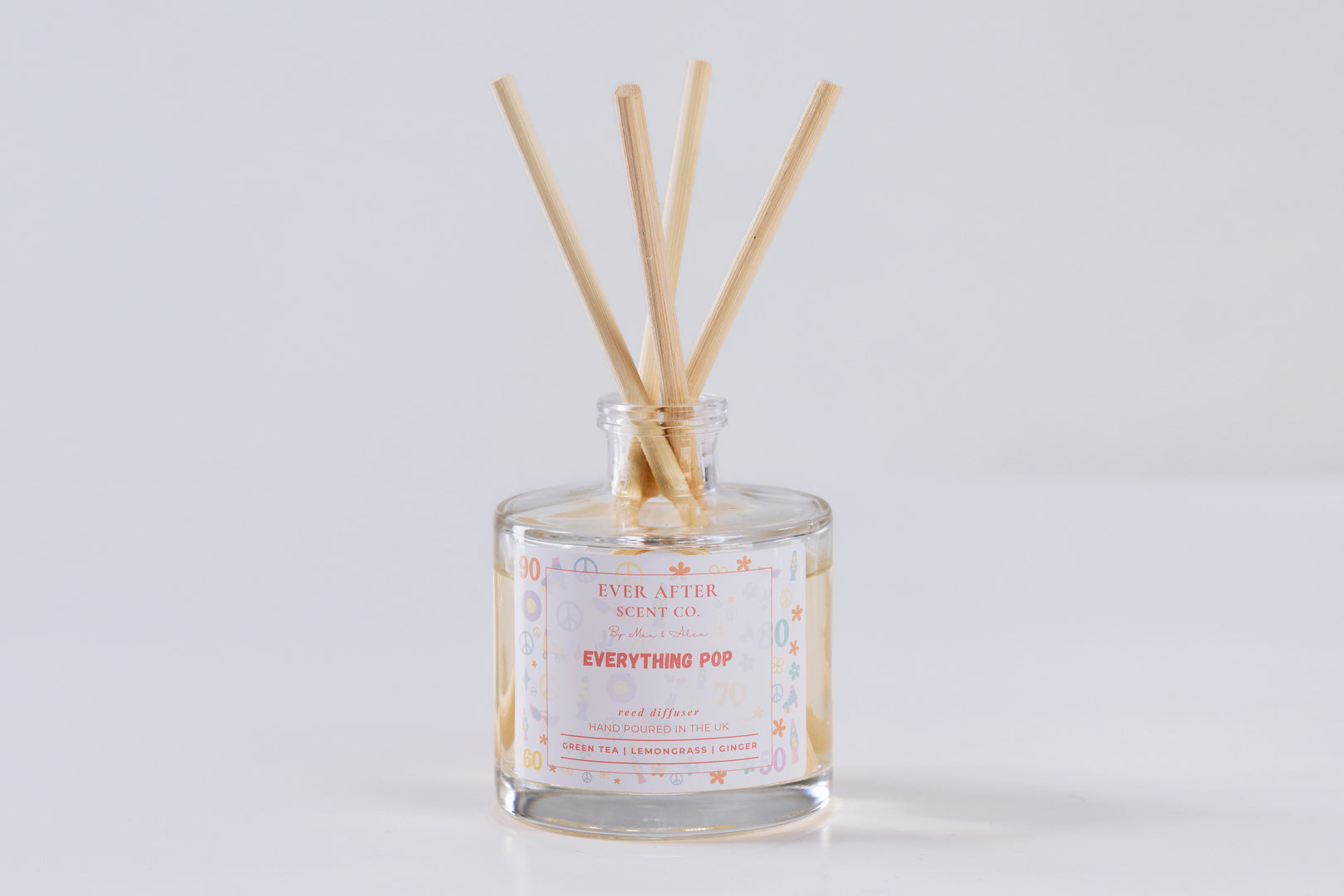 Ever After Scent Co Everything POP Reed diffuser with wooden sticks in a glass bottle on a light gray background