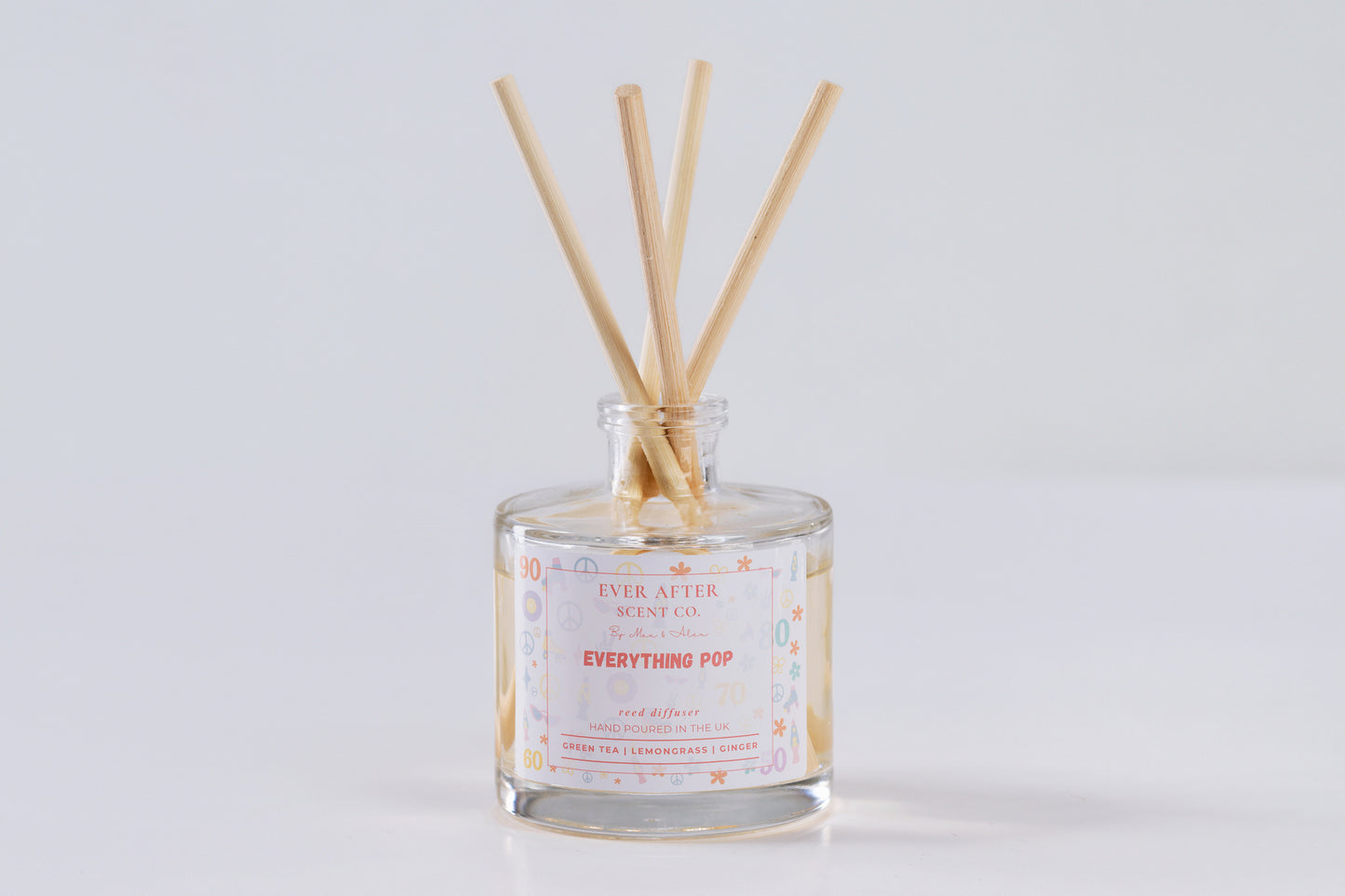 Ever After Scent Co Everything POP Reed diffuser with wooden sticks in a glass bottle on a light gray background