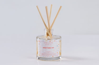 Ever After Scent Co Everything POP Reed diffuser with wooden sticks in a glass bottle on a light gray background